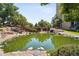 A serene pond surrounded by lush greenery offering a peaceful retreat at 7865 E Mississippi Ave # 1502, Denver, CO 80247