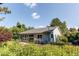 Beautiful backyard featuring a sunroom and surrounded by lush landscaping and vibrant flowers at 8888 W 37Th Pl, Wheat Ridge, CO 80033