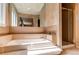 Relaxing bathroom with a soaking tub, tiled surround, a large mirror and a separate shower at 8888 W 37Th Pl, Wheat Ridge, CO 80033