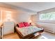 Bedroom features a platform bed, a white dresser and natural light from a single window at 8888 W 37Th Pl, Wheat Ridge, CO 80033