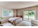 Bedroom with a queen bed, large windows, and access to a private deck at 8888 W 37Th Pl, Wheat Ridge, CO 80033