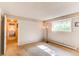 Bright, empty bedroom with warm-toned carpet and natural light from a single window at 8888 W 37Th Pl, Wheat Ridge, CO 80033