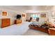 Spacious primary bedroom featuring carpet floors, big windows, and closet at 8888 W 37Th Pl, Wheat Ridge, CO 80033
