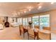 Spacious dining room with fireplace, large windows, and open layout to the living room at 8888 W 37Th Pl, Wheat Ridge, CO 80033