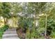 Charming home entrance featuring concrete steps and surrounded by lush greenery and mature trees at 8888 W 37Th Pl, Wheat Ridge, CO 80033