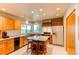 Bright kitchen with an island, wooden cabinets, and stainless steel appliances at 8888 W 37Th Pl, Wheat Ridge, CO 80033