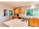 Bright kitchen featuring wooden cabinets, a stainless steel sink, and a center island at 8888 W 37Th Pl, Wheat Ridge, CO 80033
