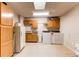Functional laundry room with ample storage cabinets, sink, and washer and dryer at 8888 W 37Th Pl, Wheat Ridge, CO 80033