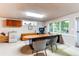 Well-lit home office with built-in desk, large windows and custom shelving at 8888 W 37Th Pl, Wheat Ridge, CO 80033