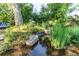 Picturesque pond with a small waterfall and lush greenery, creating a peaceful and relaxing atmosphere at 8888 W 37Th Pl, Wheat Ridge, CO 80033