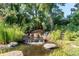 Zen garden featuring a serene pond and a gentle waterfall, surrounded by lush vegetation at 8888 W 37Th Pl, Wheat Ridge, CO 80033