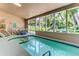 Bright indoor pool with spa, seating area, and access to the garden at 8888 W 37Th Pl, Wheat Ridge, CO 80033