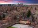 Stunning aerial view featuring Denver skyline, basketball court and home with solar panels at 1156 S Columbine St, Denver, CO 80210