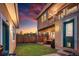 Beautifully landscaped backyard with a covered patio, lush lawn, and privacy fencing at 1156 S Columbine St, Denver, CO 80210