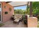 Inviting front porch offers a cozy seating area with brick accents and tranquil outdoor views at 1156 S Columbine St, Denver, CO 80210