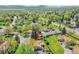 An aerial view shows a home in a verdant neighborhood, providing a sense of community and natural beauty at 9099 W Harvard Pl, Lakewood, CO 80227