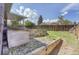 Backyard featuring a wooden fence, rock garden, and a shed under a cloudy blue sky at 9099 W Harvard Pl, Lakewood, CO 80227