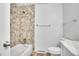 Bathroom features a tile surround shower and tub with modern wood-look flooring at 9099 W Harvard Pl, Lakewood, CO 80227