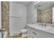 Neutral bathroom featuring a bath with a tile surround and a white marble vanity at 9099 W Harvard Pl, Lakewood, CO 80227