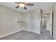 Bedroom with gray carpet, shelving, and bi-fold doors to a closet at 9099 W Harvard Pl, Lakewood, CO 80227