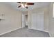 Bedroom featuring neutral walls, gray carpet, and double door closet at 9099 W Harvard Pl, Lakewood, CO 80227
