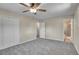 Bedroom features neutral walls and gray carpet, with bathroom access at 9099 W Harvard Pl, Lakewood, CO 80227
