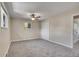 Bedroom with gray carpet, neutral walls, ceiling fan, and bi-fold doors at 9099 W Harvard Pl, Lakewood, CO 80227