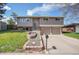 Charming two-story home with a manicured lawn, beautiful terraced garden, and an attached two-car garage at 9099 W Harvard Pl, Lakewood, CO 80227