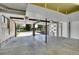 Spacious garage with open doors and ample storage space, leading to the driveway and street at 9099 W Harvard Pl, Lakewood, CO 80227