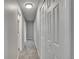 Hallway with neutral colors and closets for storage at 9099 W Harvard Pl, Lakewood, CO 80227