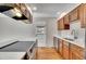 Modern kitchen with stainless appliances, white countertops, and beautiful hardwood floors at 9099 W Harvard Pl, Lakewood, CO 80227