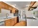 Updated kitchen with hardwood floors, stainless appliances, and quartz countertops at 9099 W Harvard Pl, Lakewood, CO 80227