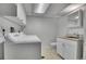 Bright laundry room area featuring a washer, dryer, sink, and toilet at 9099 W Harvard Pl, Lakewood, CO 80227