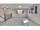 Bright, spacious living room featuring new carpet, neutral walls, and large windows offering plenty of natural light at 9099 W Harvard Pl, Lakewood, CO 80227