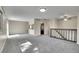 Spacious living area with new carpet, neutral paint, with a half wall and breakfast bar into the kitchen at 9099 W Harvard Pl, Lakewood, CO 80227