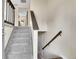The home features a well-lit stairway with carpeted steps and classic wooden railing, leading to the upper level at 9099 W Harvard Pl, Lakewood, CO 80227