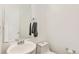 Small bathroom with pedestal sink and toilet at 4849 Halifax Ct, Denver, CO 80249