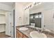 Bathroom with double sinks and a large mirror at 4849 Halifax Ct, Denver, CO 80249