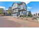 Two-story home with gray siding and a paved driveway at 4849 Halifax Ct, Denver, CO 80249