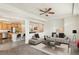 Open living room with a modern sofa and a view into the kitchen at 4849 Halifax Ct, Denver, CO 80249