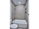 Modern bathroom with tub, shower, and decorative tile, creating a relaxing space at 1823 Grove St, Denver, CO 80204