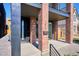 Charming entryway with modern door, house number, and sleek black mailbox, with brick columns and a concrete porch at 1823 Grove St, Denver, CO 80204