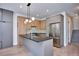 Bright modern kitchen with an island, stainless steel appliances, and gray and wood cabinetry at 1823 Grove St, Denver, CO 80204