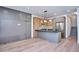 Bright kitchen features gray island, wooden cabinetry, stainless steel appliances, and sleek pendant lighting at 1823 Grove St, Denver, CO 80204