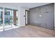 Bright living room with light wood floors, large windows, and a modern accent wall with built-in cabinets at 1823 Grove St, Denver, CO 80204