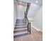 Modern staircase with wood treads and black metal railing provides access to multiple levels in the home at 1823 Grove St, Denver, CO 80204