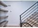Stairway with floating shelves, light wood treads, and dark metal railings at 1823 Grove St, Denver, CO 80204