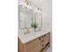 Bathroom vanity with double sinks, wood cabinets, white countertop, and gold fixtures at 3440 N Harrison St, Denver, CO 80205