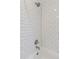 Bright white tiled shower with a shower head at 3440 N Harrison St, Denver, CO 80205