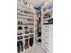 Custom closet organizer with white shelves, drawers, and hanging rods for ample storage at 3440 N Harrison St, Denver, CO 80205
